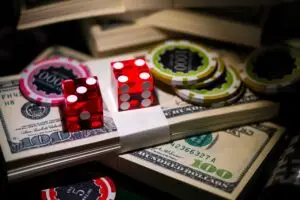 craps dice, money, and casino chips