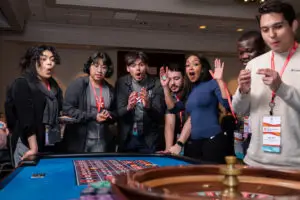 Excited players standing around roulette, a popular casino game for casino events