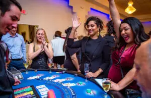 Players cheering around a blackjack table