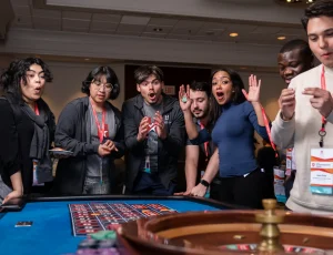 Excited players standing around roulette, a popular casino game for casino events