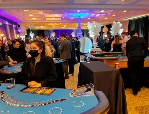Casino fundraiser with guests actively playing at casino tables.